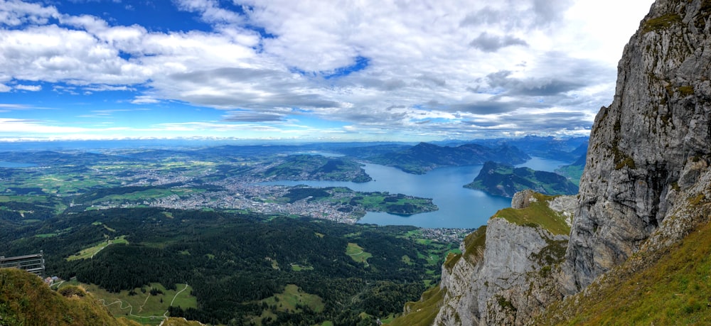 green mountains under blue sky and white clouds during daytime