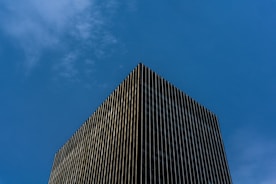 black and white concrete building under blue sky during daytime