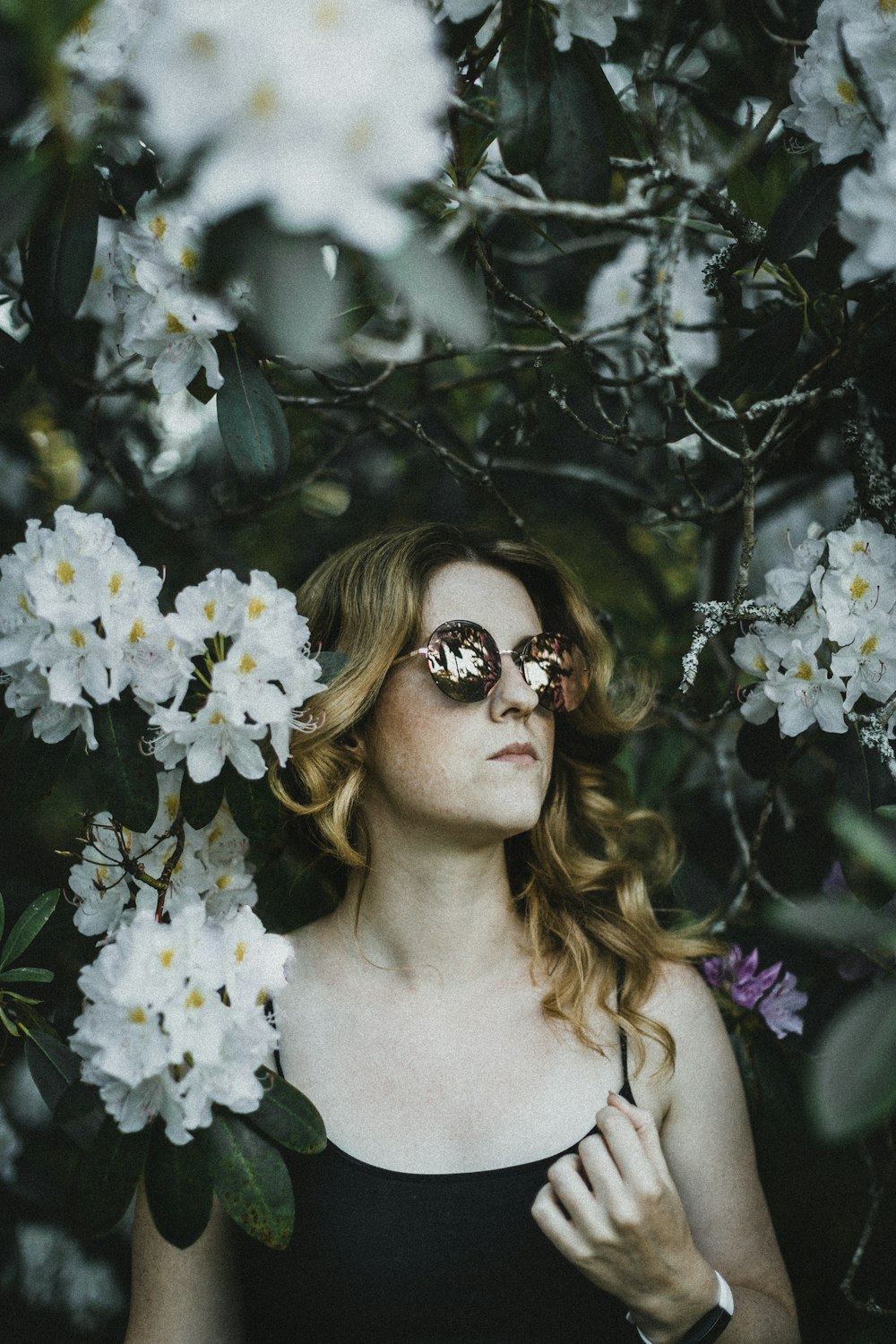 woman in white floral dress wearing brown sunglasses