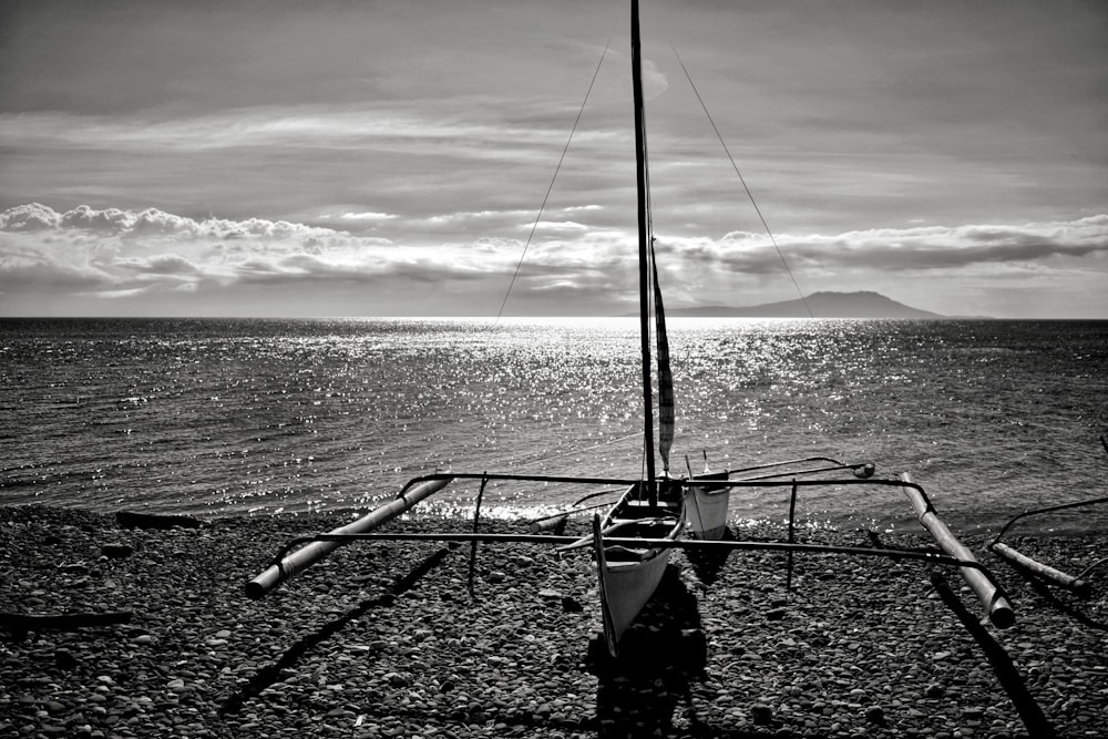 black and white fishing net on gray sand during daytime