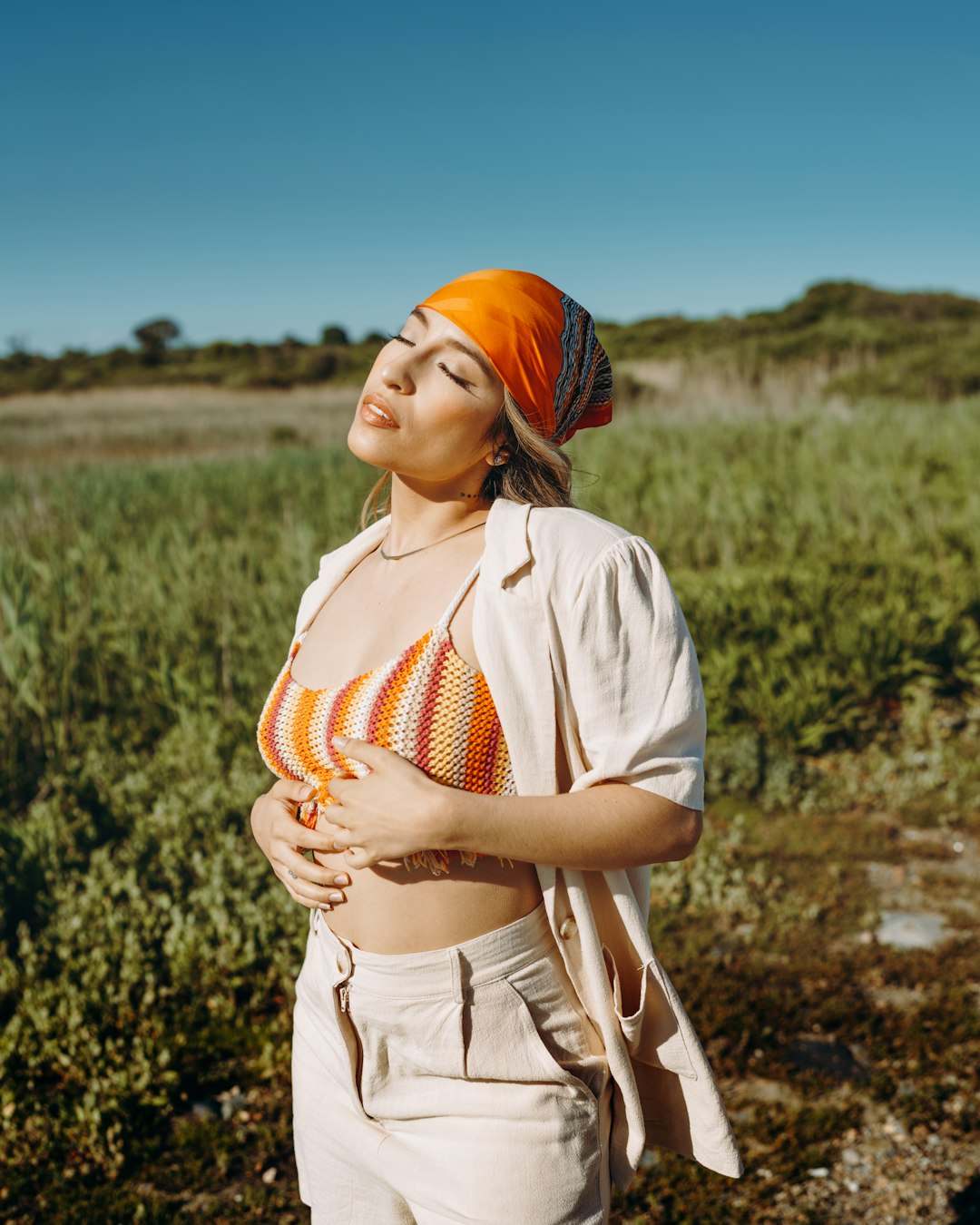 woman in white and orange dress wearing orange hijab