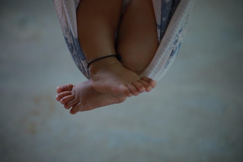 person lying on white hammock