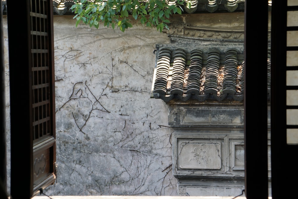 brown wooden window frame on gray concrete wall