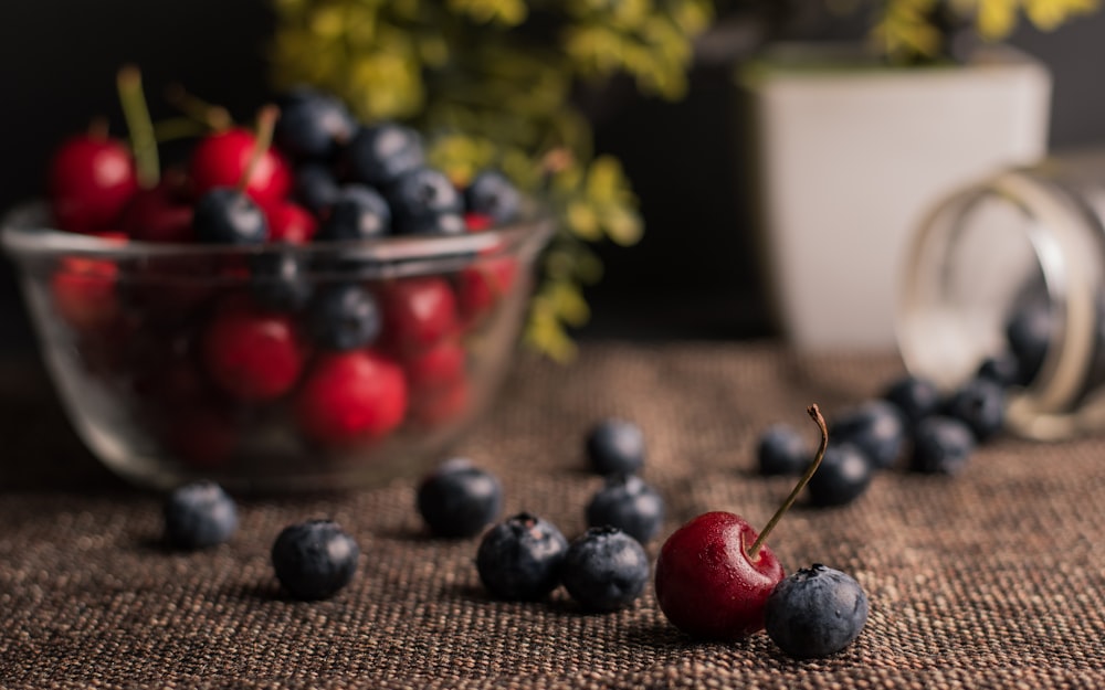 red and blue berries in clear glass bowl