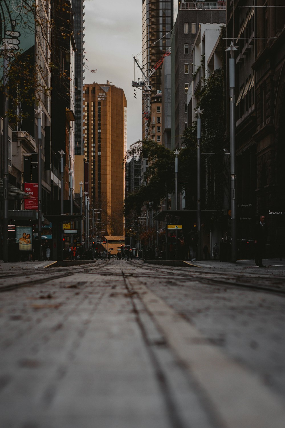 gray concrete road between high rise buildings during daytime