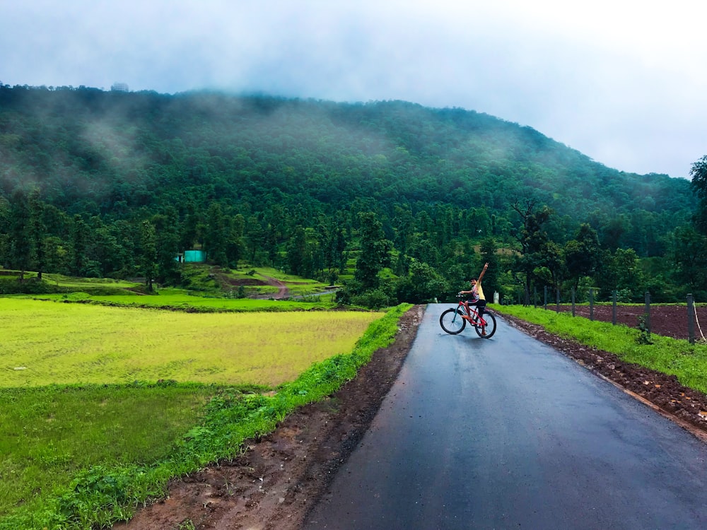 man riding bicycle on road during daytime