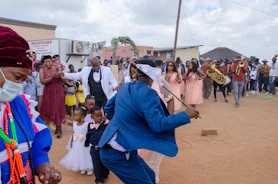 A lively group of wedding guests dancing together in celebration