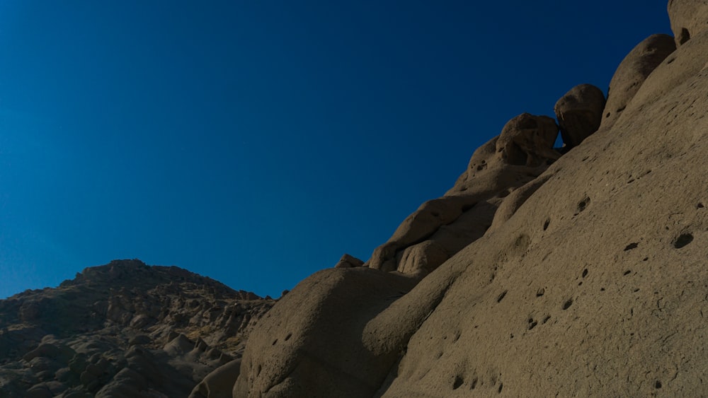 brown rocky mountain under blue sky during daytime