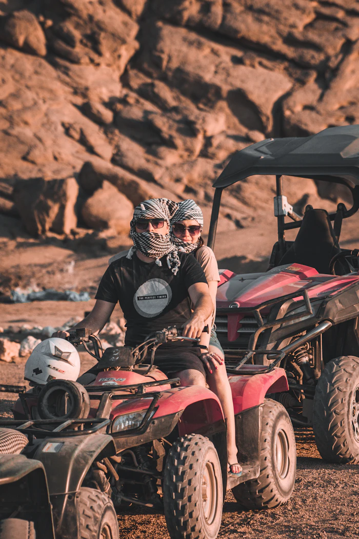 Couple riding a quad bike in the desert near Marrakech