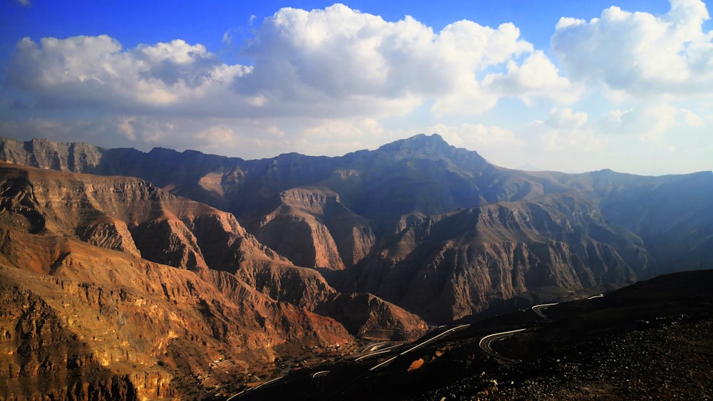 black car on road near mountains during daytime