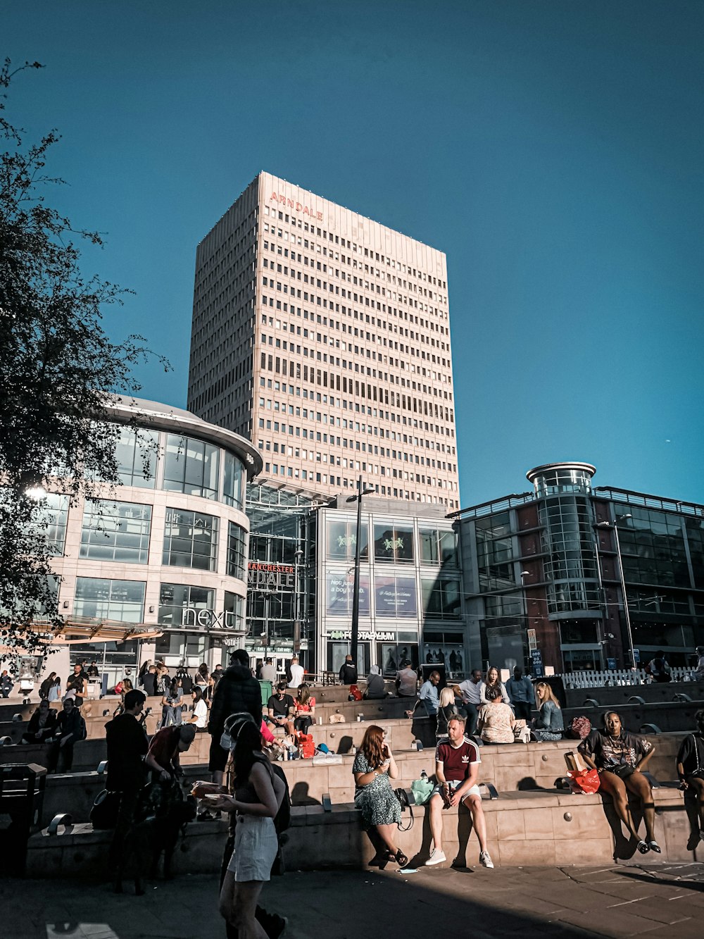 people sitting on bench near building during daytime