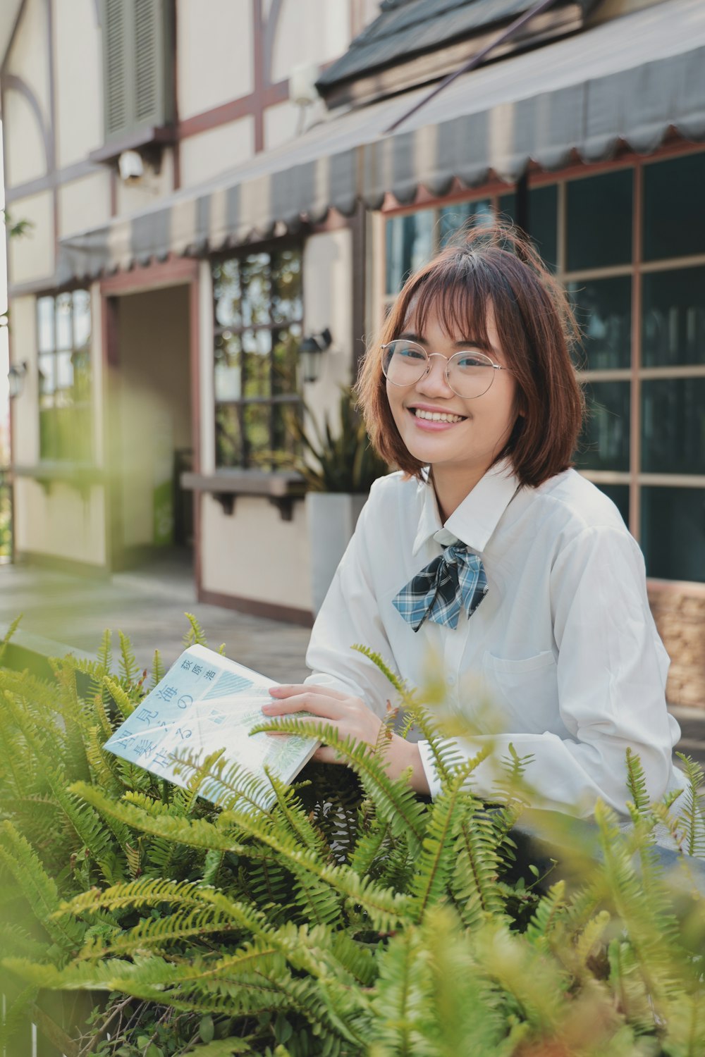 woman in white dress shirt smiling