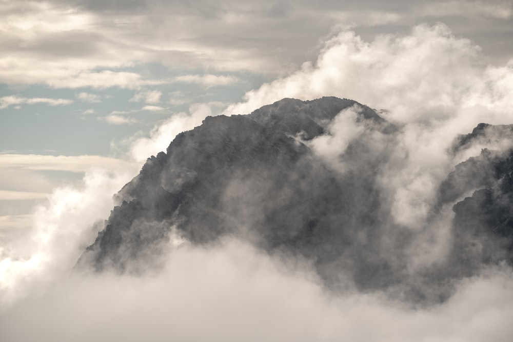 white clouds over black mountain