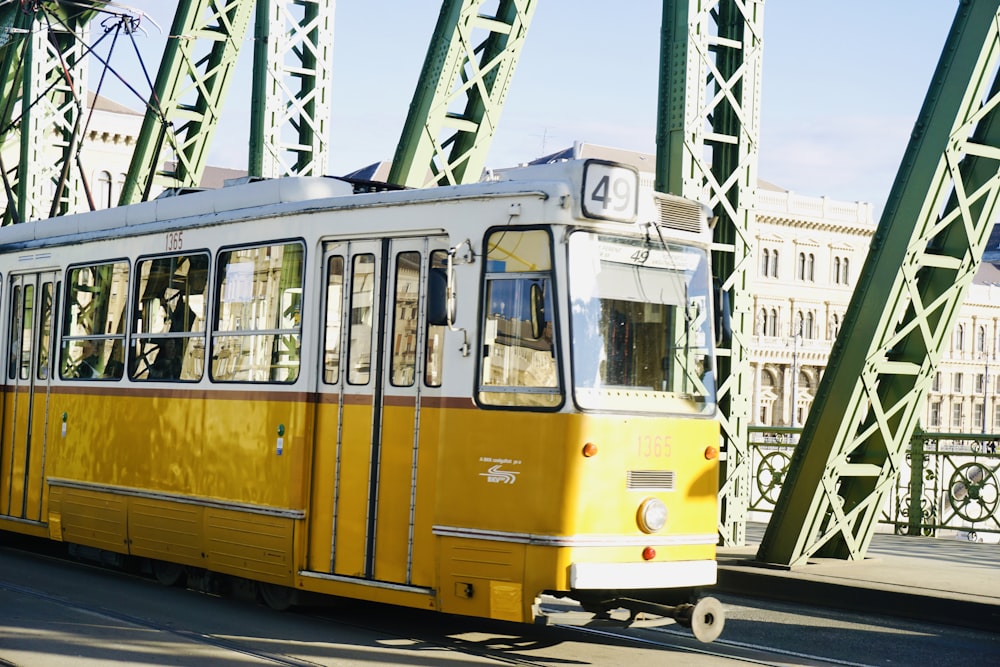 yellow and white train on rail