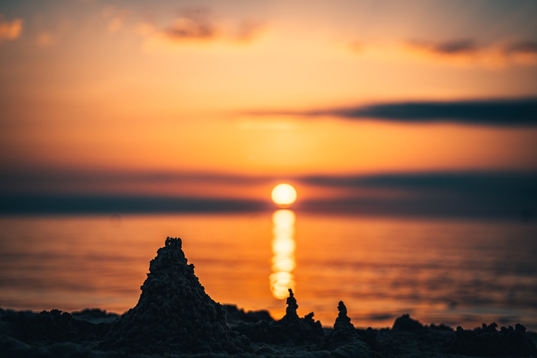 silhouette of rock formation during sunset