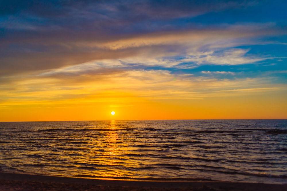 body of water during sunset