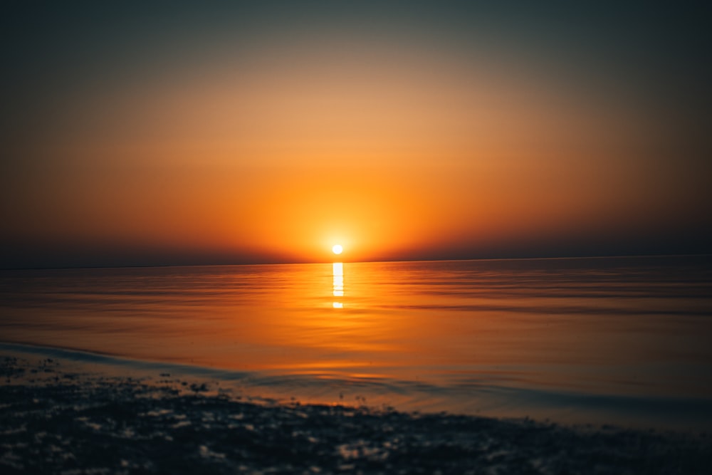 body of water during sunset