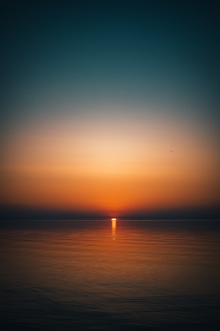 body of water during sunset