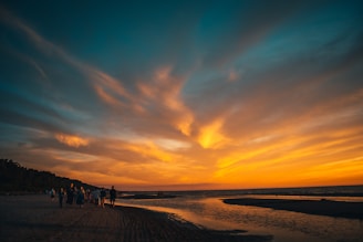 A group of travelers walking through a stunning coastal circuit at sunset.