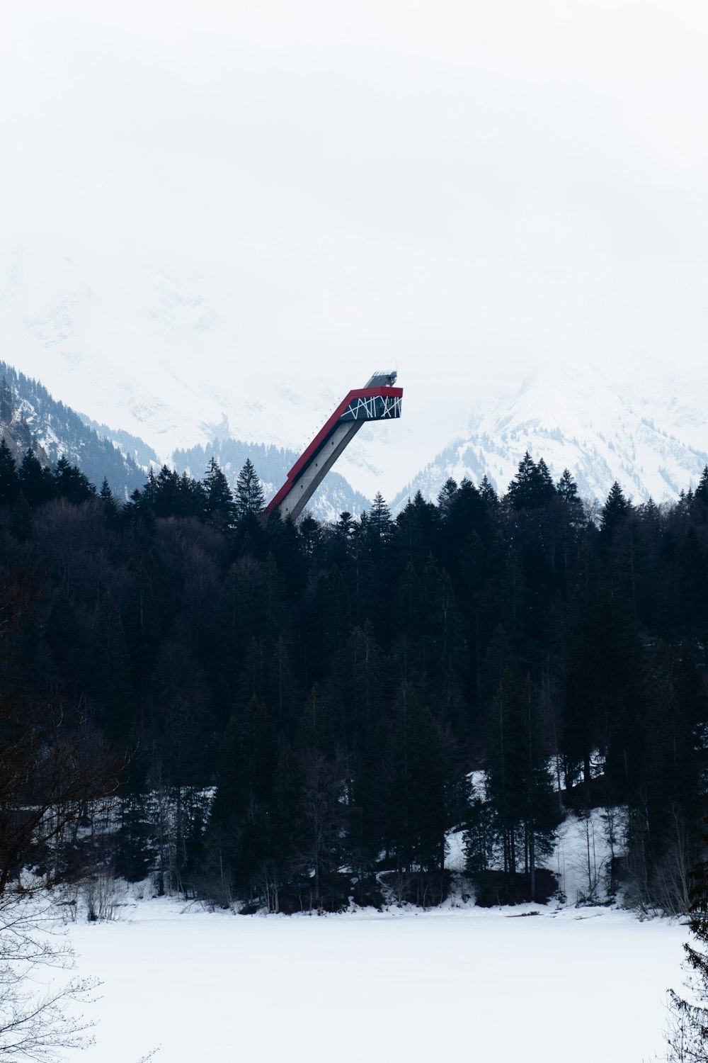 red tower in the middle of forest