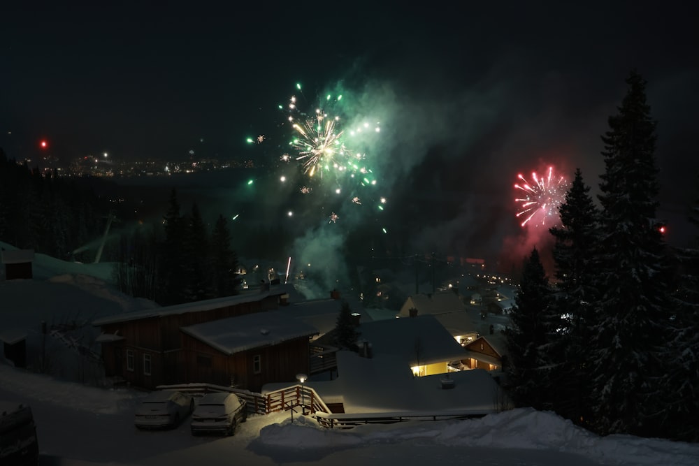 fireworks display over houses during night time
