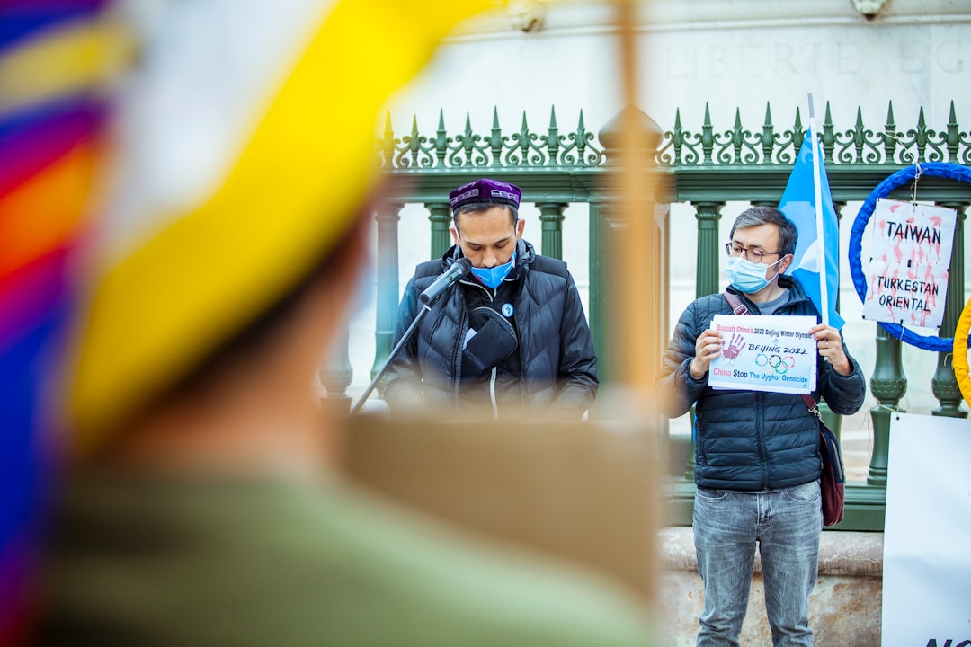 man in blue denim jacket and blue denim jeans standing beside man in blue denim jacket