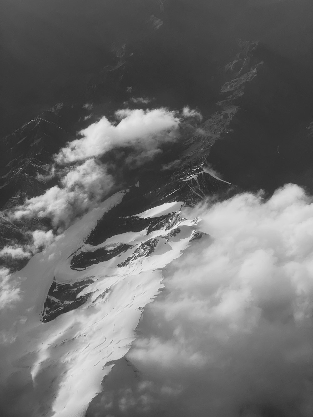 grayscale photo of clouds and mountain