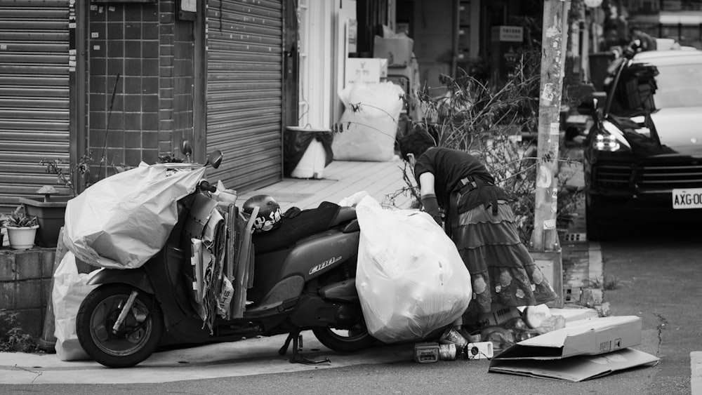 grayscale photo of man sitting on motorcycle