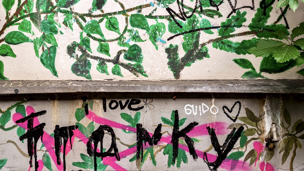 purple and green graffiti on brown wooden wall