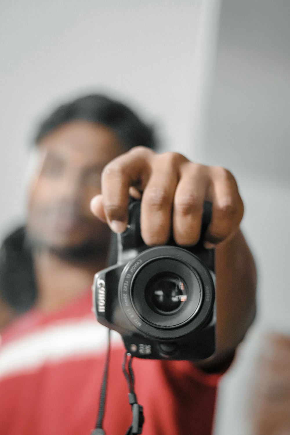 person holding black canon dslr camera