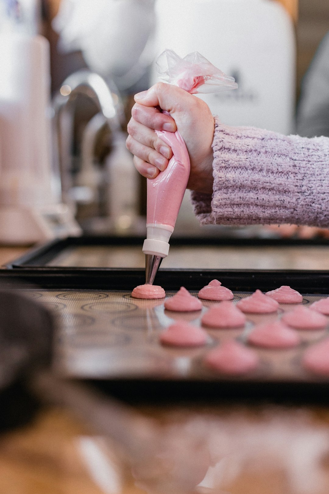 person holding pink nail polish