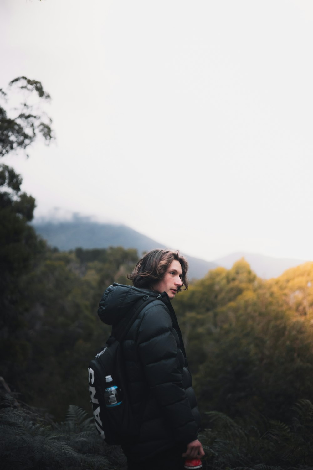 woman in black jacket standing on mountain during daytime