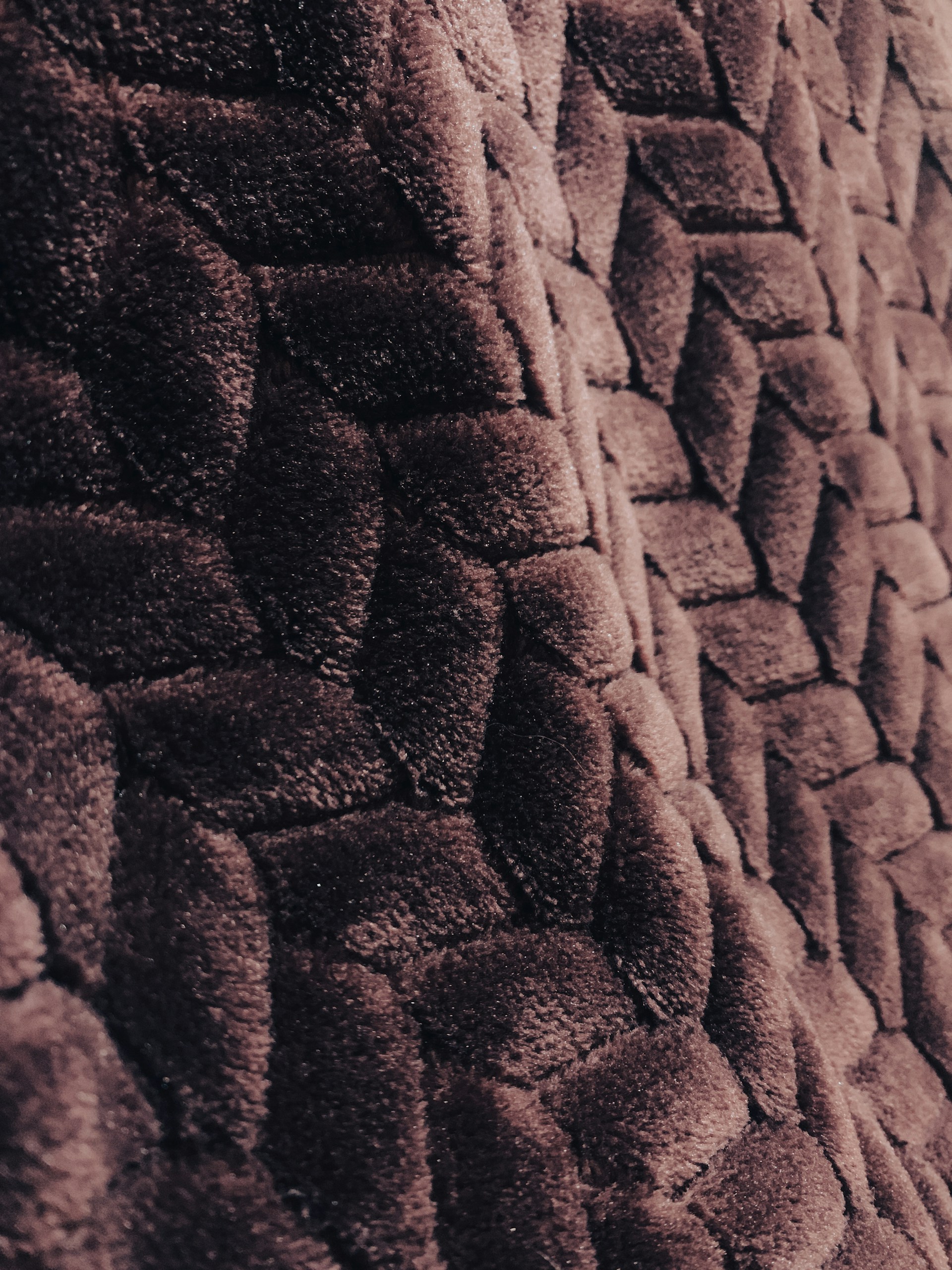 Close-up of a towel's plush texture, highlighting the fine weave and rich color, inviting you to feel its softness.