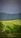 A scenic view of a winding road through lush green hills.