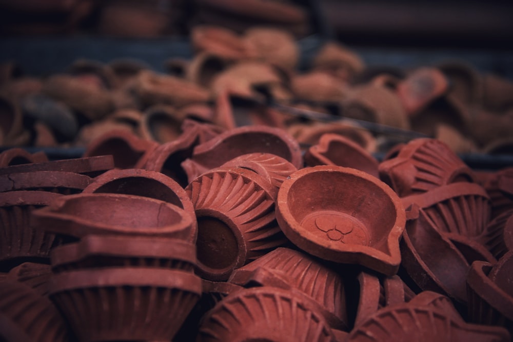 a pile of clay cups sitting on top of a table