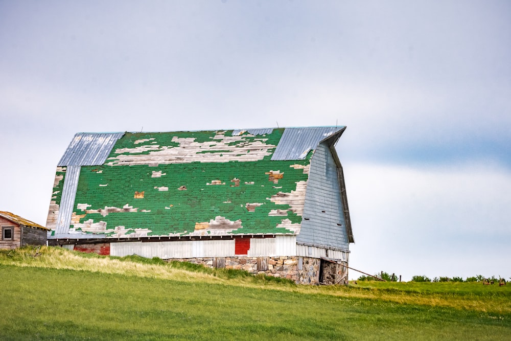 red and white wooden house on green grass field under white sky during daytime