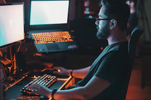 man in blue shirt using computer