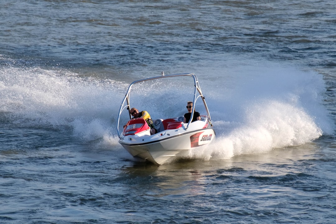 white and red speedboat on sea during daytime
