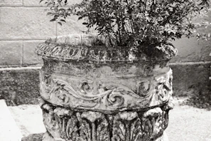 Close-up of a handcrafted planter showcasing fine metalwork details.