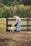 man in blue dress shirt holding white short coated dog during daytime