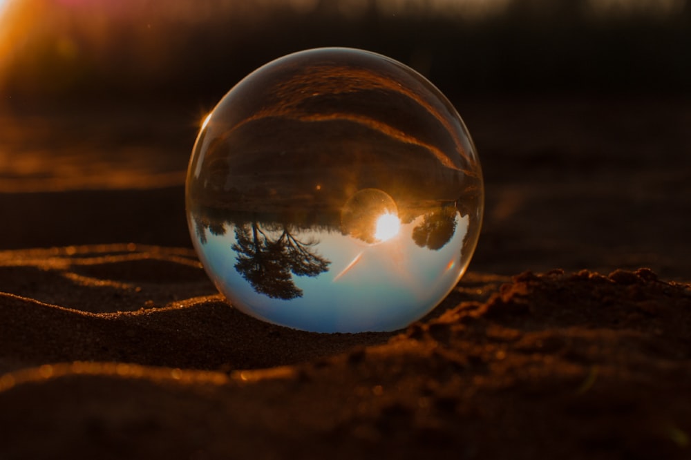 clear glass ball on brown soil