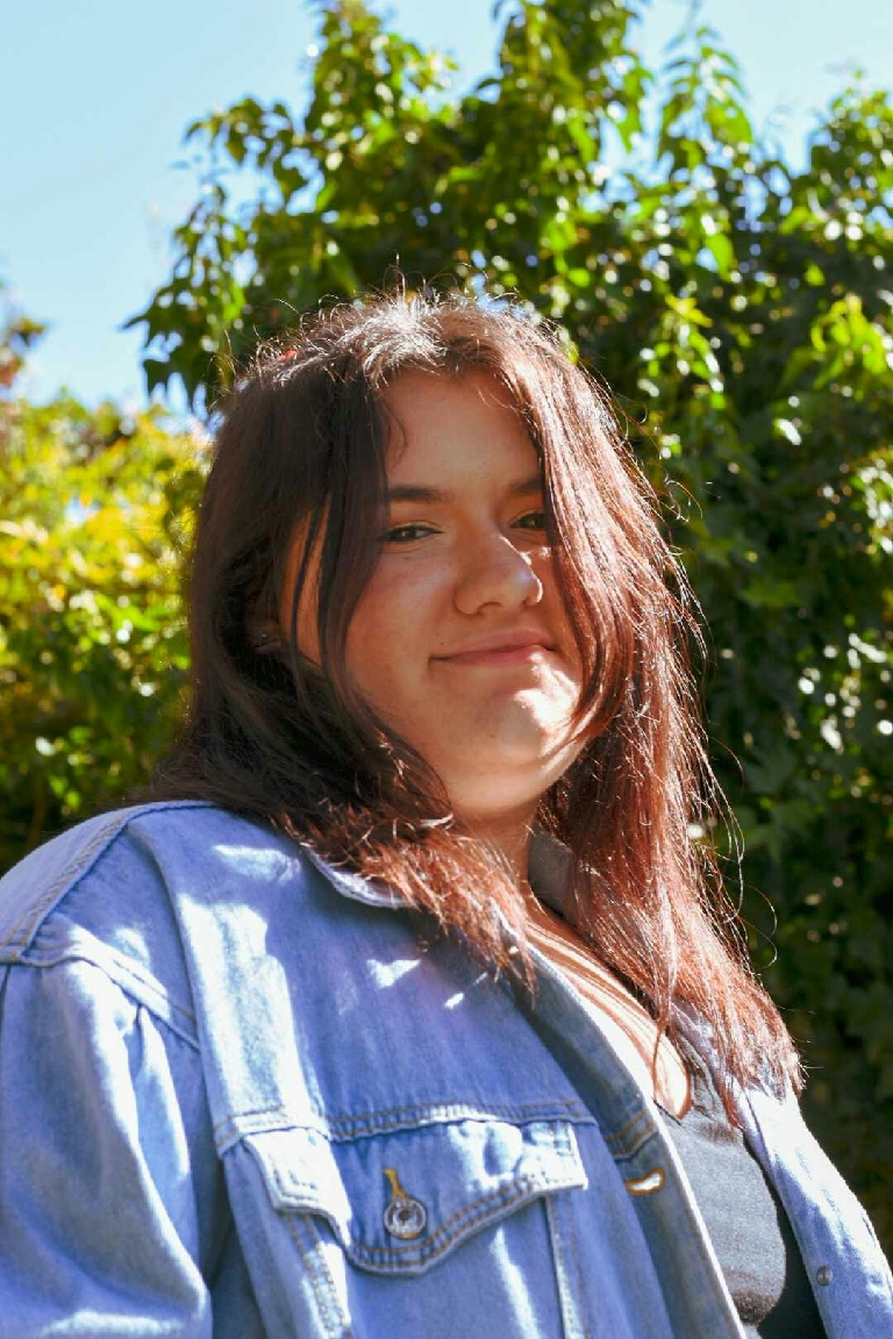 woman in blue and white shirt smiling