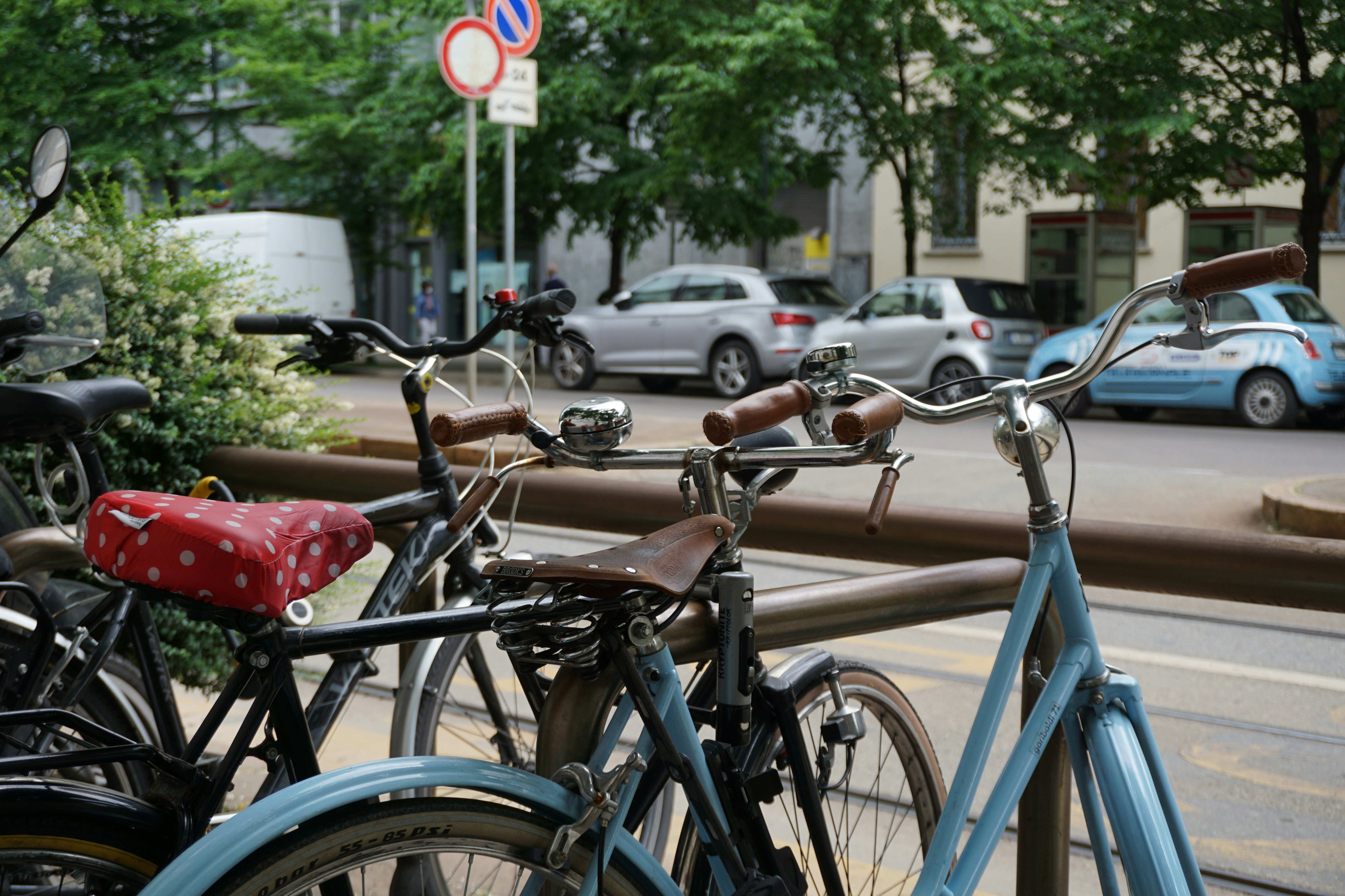 blue and black bicycle parked on sidewalk during daytime