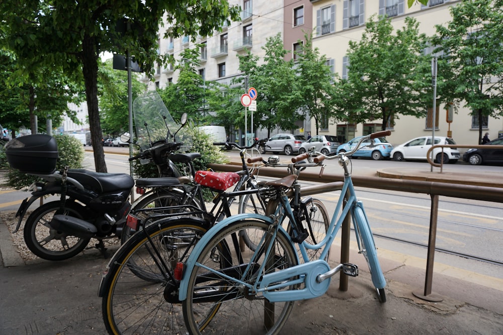 blue city bike parked on sidewalk during daytime