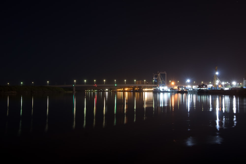 lighted bridge over water during night time