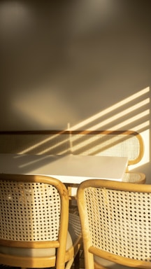 Sunlit dining area with minimalist decor and soft neutral tones.