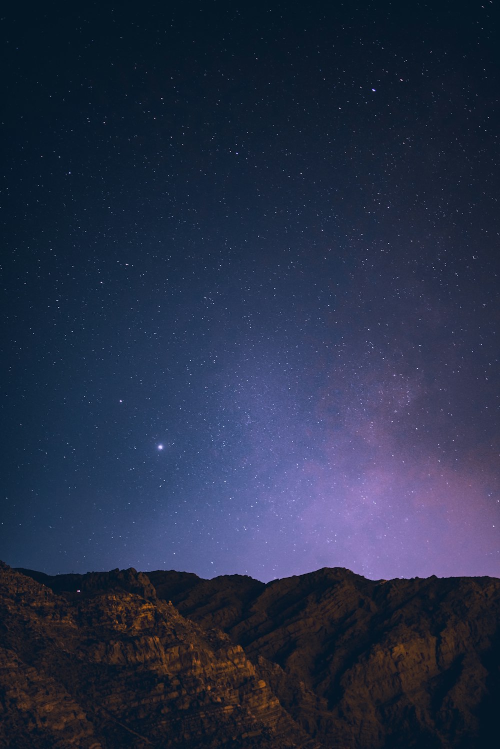 brown mountain under blue sky during night time