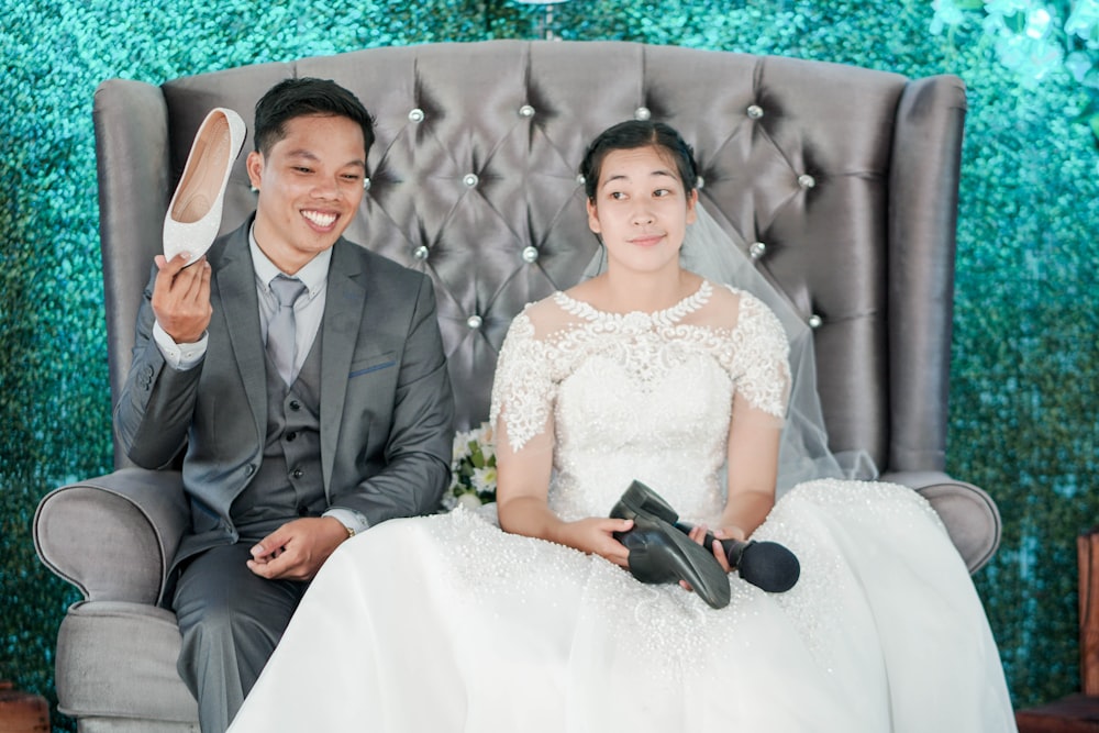 man in black suit jacket beside woman in white wedding dress