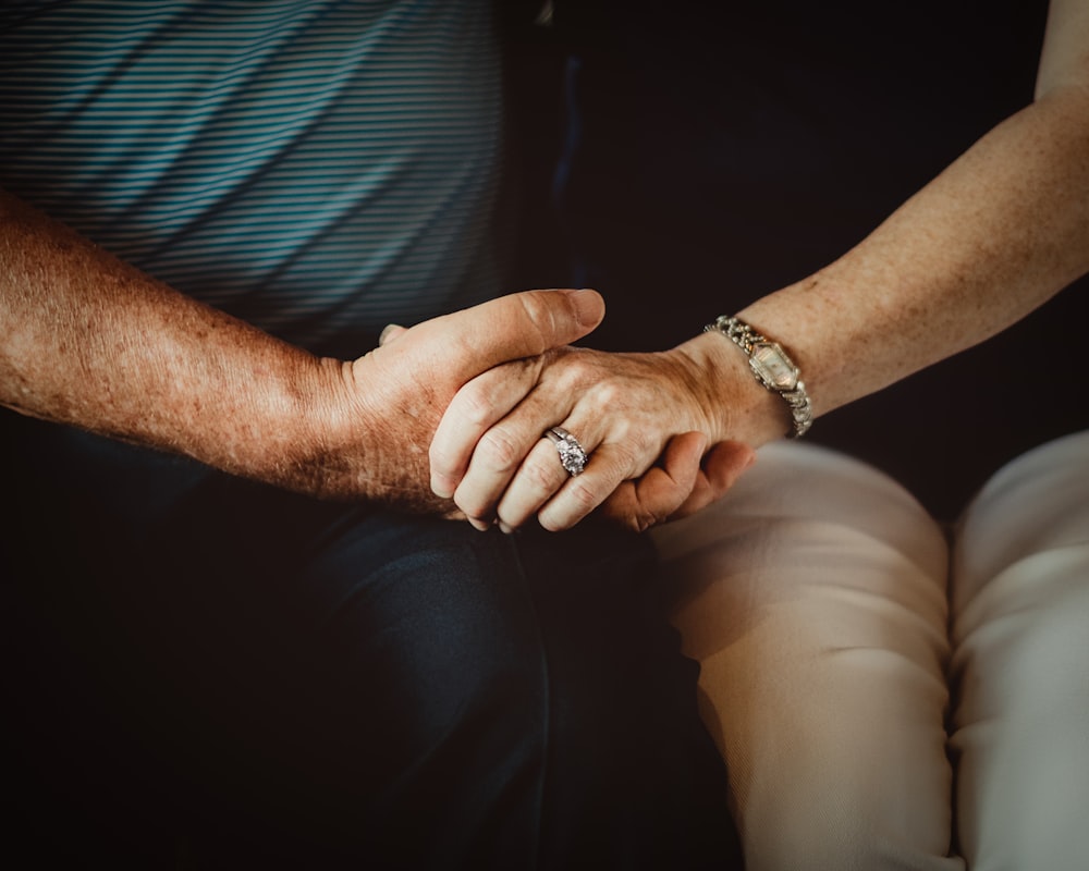 person wearing silver ring and silver ring