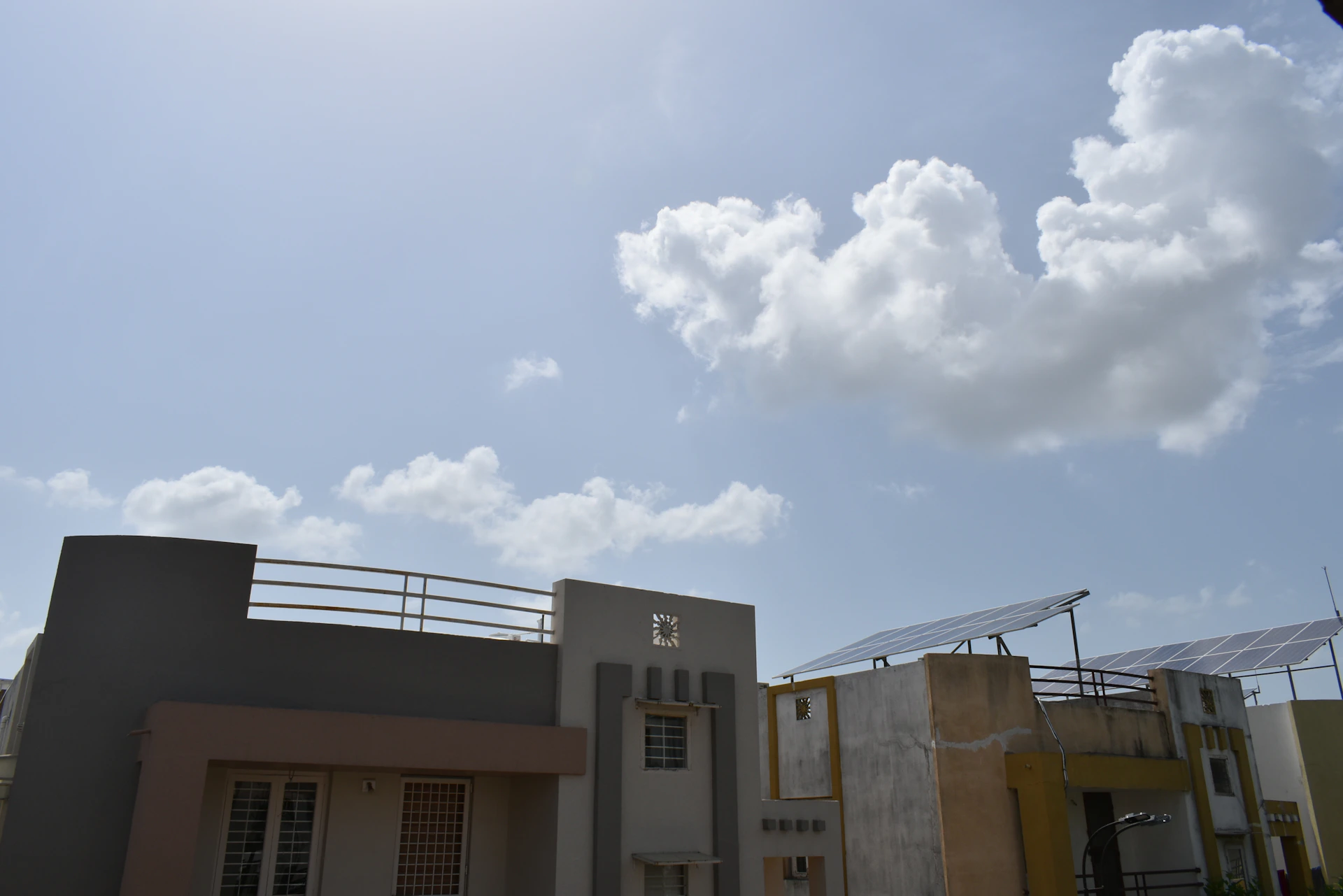 woman wearing yellow long-sleeved dress under white clouds and blue sky during daytime